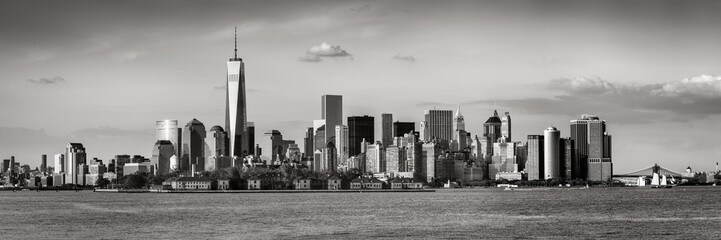 Lower Manhattan with the Financial District skyscrapers and Ellis Island. Panoramic view of New York City. Black & White