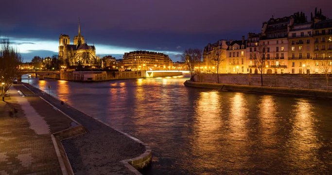 The Seine River banks by the Ile Saint Louis and Ile de la Cite with Notre Dame Cathedral at twilight (time-lapse). Paris, 4th Arrondissement, France
