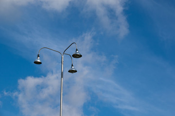 outdoor lamppost on the street with a clear blue sky background.