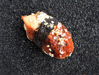 Nigiri Sushi with Smoked Eel and Seaweed Nori on Dark Background