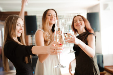 Group people with champagne dancing at the party.