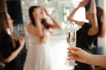 Group people with champagne dancing at the party.