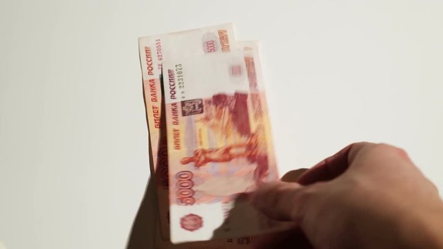 Unrecognizable person counting russian roubles money closeup