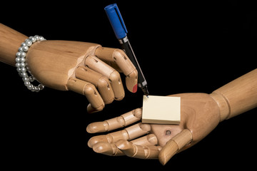 Woman's hand written on a note held in his other hand. Empty notepad for template for your project....