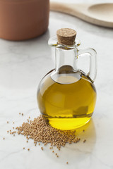 Bottle with mustard oil and seeds