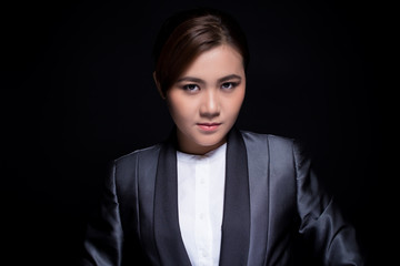 Scheming businesswoman planing something isolated on black background