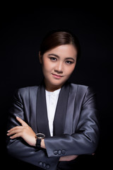 Scheming businesswoman planing something isolated on black background