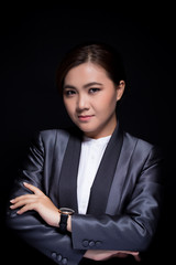 Scheming businesswoman planing something isolated on black background