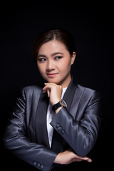 Scheming businesswoman planing something isolated on black background
