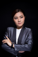 Scheming businesswoman planing something isolated on black background