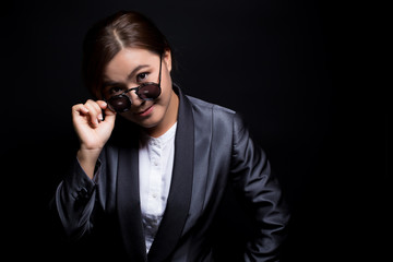 Seriously businesswoman wearing sun glasses on isolated background