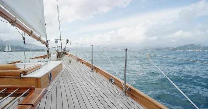Wooden luxury sailboat sailing over ocean in beautiful blue mediterranean sea