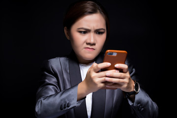 Fototapeta premium Woman use the smartphone and she feel angry