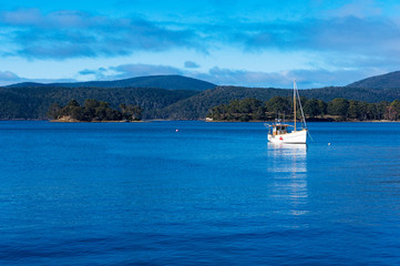 White yacht in lagoon on sunny day