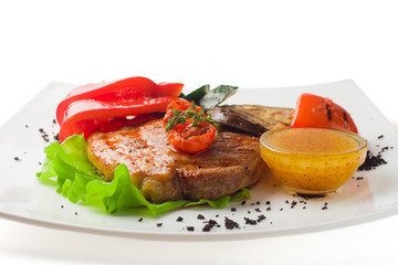 juicy grilled pork with vegetables on a white background, isolated