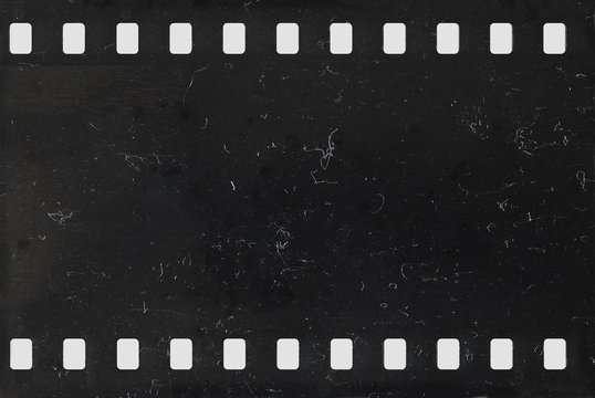 Fototapeta Strip of old negative celluloid film with dust and scratches