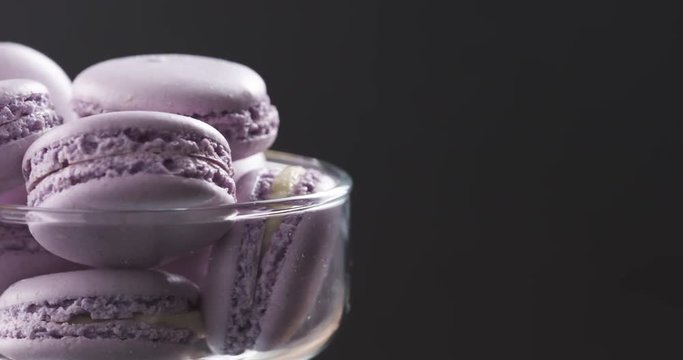 lavender violet macarons in glass bowl rotating loopable video, 4k prores footage