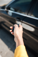Woman hand holding keys and closing door of her car