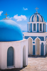 Fototapeta na wymiar Two Greek church domes in traditional colors. Taken on Santorini Island. No people.