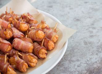 Deep fried sausages rolled in bacon