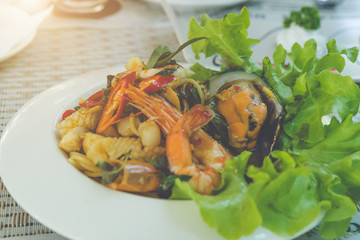 Spicy seafood spaghetti on white plate.(Selective focus)
