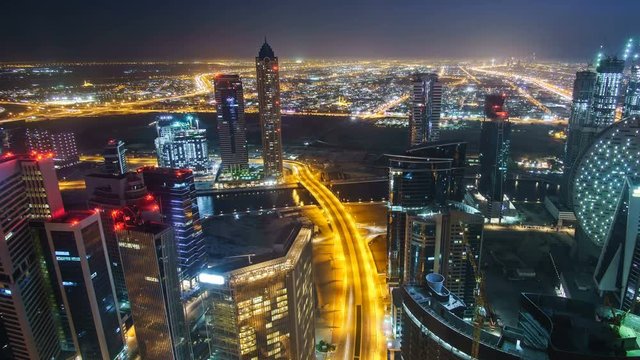 Fantastic nighttime skyline of downtown Dubai. Scenic aerial view of highway and skyscrapers.. 4K time lapse. Travel background.