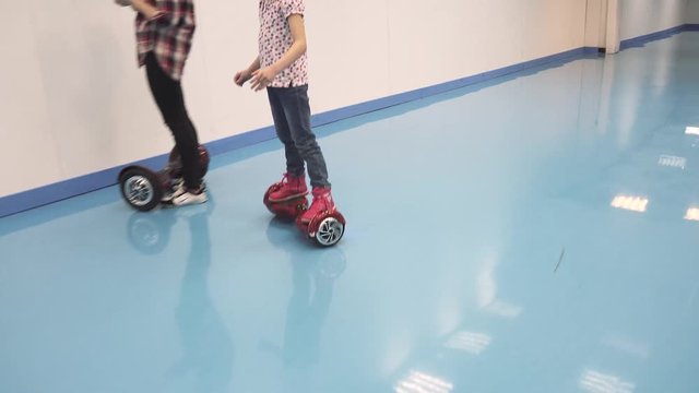 little girl is riding a hyroscooter. child learns to ride on segway
