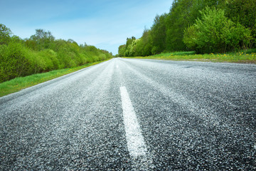 Fototapeta premium Asphalt road in beautiful spring day at countryside