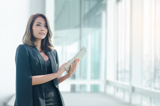 Beautiful Asian Businesswoman Using Tablet In Office