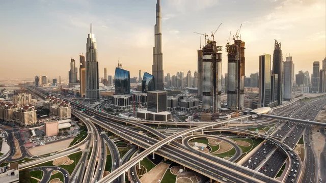 Beautiful daytime cityscape of downtown Dubai, UAE. Scenic aerial view of famous highway interchange with dense traffic. Transportation and travel background. 4K time lapse.