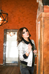 Girl posing in a silver jacket. The Studio photos. r