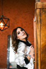 Fototapeta premium fashion beautiful woman wearing a silver jacket.