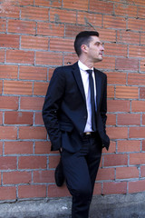 Man in suit with hands in pockets