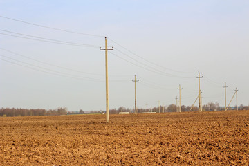 Landscape with plowed land and road in spring