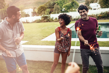 Young friends celebrating new years eve in backyard