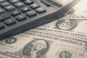 Fototapeta premium Calculator with american dollars on the wooden table background, finance concept, pencil, phone