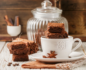 Squares brownie in a white Cup. Chocolate dessert. Traditional dish of American cuisine. Selective focus