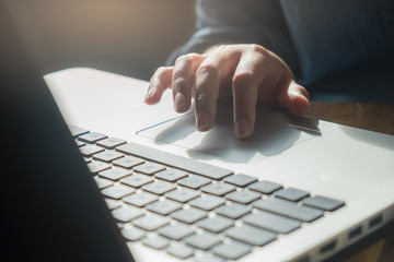 Woman finger touching on laptop touch pad
