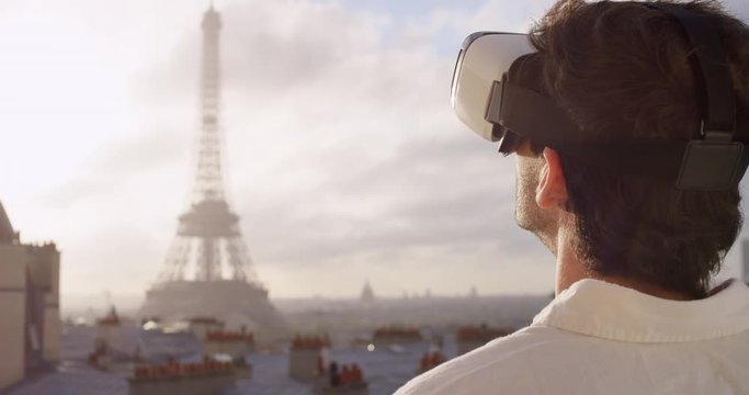 Tourist Man looking at Eiffel Tower Paris wearing virtual reality headset  watching 360 video imagination concept at sunrise sunset