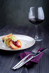 Goose liver with cherry sauce and apples and a glass of wine
