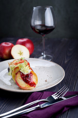 Goose liver with cherry sauce and apples and a glass of wine