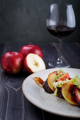 Goose liver with cherry sauce and apples and a glass of wine