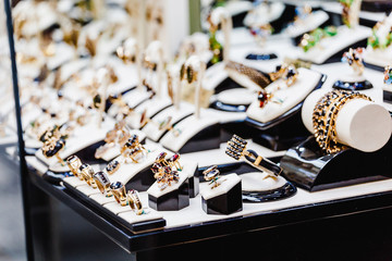 Set of luxury jewelry with precious gems and stones on a showcase of a shop