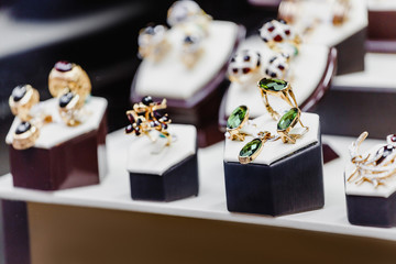 Set of luxury jewelry with precious gems and stones on a showcase of a shop