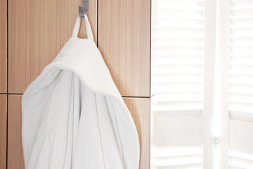 Bathrobe hanging on hook at spa salon