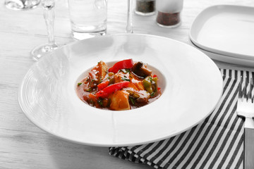 Plate with tasty chicken cacciatore on table