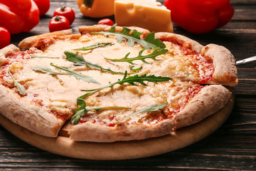 Delicious pizza with slice on shovel, closeup