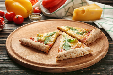 Tasty pizza slices on cutting board