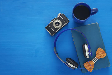 cup of coffee, old book, vintage photo camera and headphones