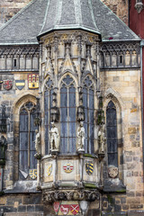 Closeup of Prague Town Hall facade decorations with sculptures and stained glass window, Czech Republic